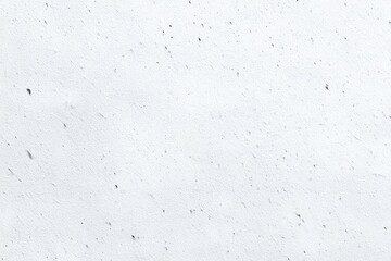 Obraz premium Close-up view of a textured, light gray surface. Tiny dark specks are dispersed throughout