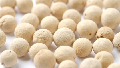 Fototapeta premium Close-up of White Peppercorns on a White Background, Culinary Spice Ingredient