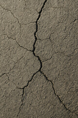 Fototapeta premium Close-up of cracked dry earth showing texture and pattern