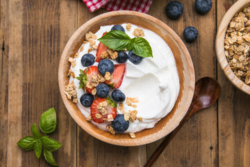 Healthy breakfast bowl with crunchy granola, creamy yogurt and fresh berries. Nutritious and delicious meal, perfect for a balanced diet and clean eating lifestyle