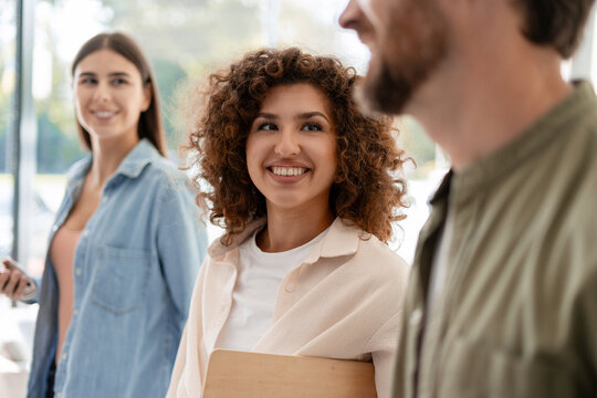 Young businesspeople smiling and walking together in the office