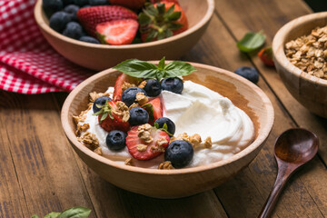 Healthy breakfast bowl with crunchy granola, creamy yogurt and fresh berries. Nutritious and delicious meal, perfect for a balanced diet and clean eating lifestyle