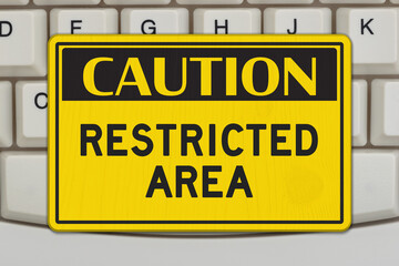 Caution Restricted Area sign on computer keyboard