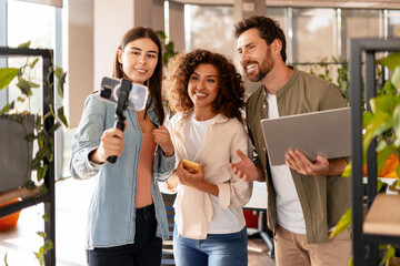 Content creators filming video blog using action camera and tablet