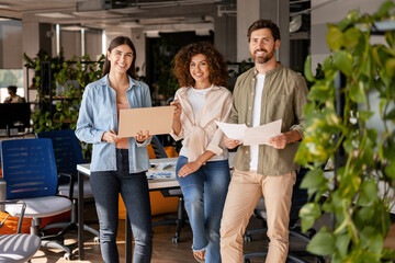 Fototapeta premium Marketing team working together in modern office using laptop and documents