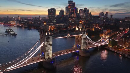 Aerial view of illuminated tower bridge over thames river with london skyline at night, london, england, united kingdom. - Powered by Adobe