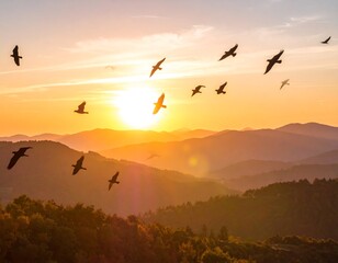 Birds soar over golden mountains at sunset