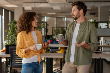 Business people discussing during coffee break in modern office