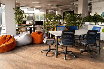 Modern coworking open space office with plants and beanbag chairs