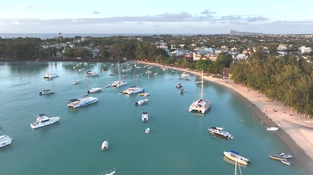 Aerial view of beautiful Grand Baie with boats in a tranquil harbor and scenic coastline, Riviere du Rempart, Mauritius.