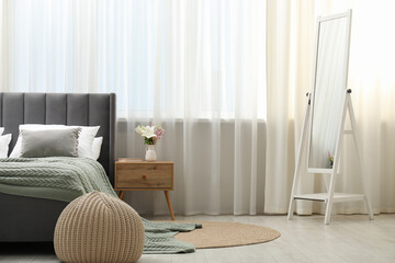 Stylish furniture near window with curtains in living room. Interior design