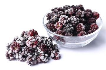 Many ripe frozen blackberries on white background