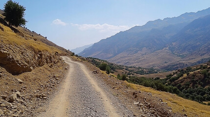 Winding path through mountainous terrain offering panoramic vista of lush valleys