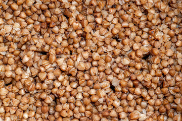 Plate with tasty buckwheat porridg.Boiled buckwheat porridge in ceramic pot on wooden background.