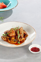 Pork medallions in sweet chili sauce with grilled potatoes and mushrooms, bright lighting, overhead composition