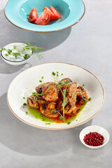 Pork medallions with sweet chili sauce, grilled potatoes and mushrooms, bright overhead composition