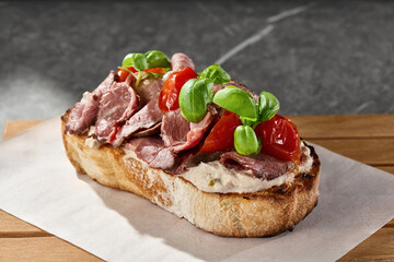 Roast beef bruschetta with tomatoes on rustic bread, bright lighting, angled composition