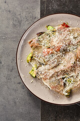 Prosciutto carpaccio layered on grilled vegetables, bright rustic lighting, overhead flatlay composition