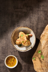 Kataifi-wrapped shrimp rustic bright overhead composition with mango dipping sauce and ceramic dishware