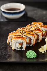 Unagi roll with avocado and salmon, glossy unagi sauce, moody lighting, closeup composition