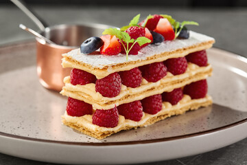 Mille-feuille with raspberries and berries, bright rustic lighting, elegant closeup composition