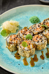 Tempura salmon roll, bright rustic, overhead plate composition with sauce and garnish