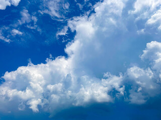 Dramatic white clouds in a bright blue sky during a sunny day