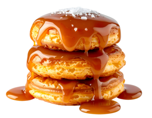 Stack of fluffy pancakes with salted caramel sauce dripping and sea salt crystals on isolated background