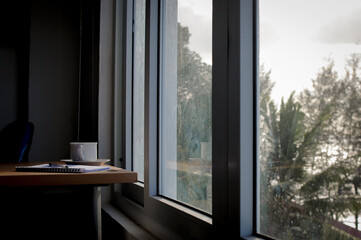 Cup of coffee and laptop on vintage iron table.