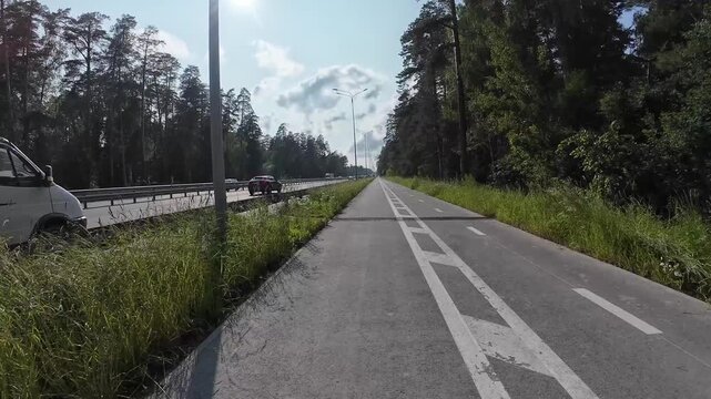 cycling on a bike path outside the city, first-person view, timelapse
