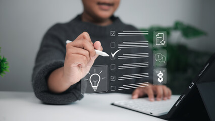 Young boy checking off a task on a digital checklist using a stylus pen on tablet, with icons like lightbulb, document, and chatbot, symbolizing task management, creativity, and education.