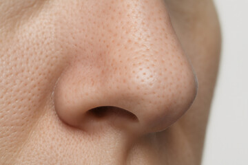 Human Nose Close-Up: A detailed, macro perspective of the human nose reveals intricate skin textures and natural contours.