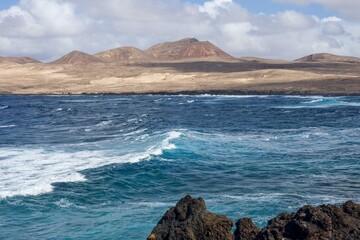 “Natural rugged beach landscape with powerful ocean waves in Lanzarote”