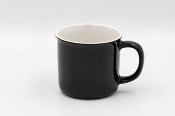 Black ceramic mug standing on white background