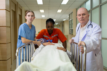 Emergency medical team rushing patient on stretcher