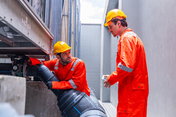 Technician inspecting industrial cooling system