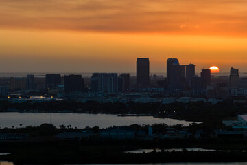 Fototapeta premium Aerial view of downtown district of Tampa city in Florida, USA at sunset. Dark silhouette of high skyscraper office buildings in modern american midtown