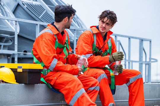 Construction workers taking hydration break on rooftop