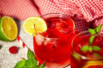 Bold berry drink with lime in harsh light - summer intensity and freshness captured.