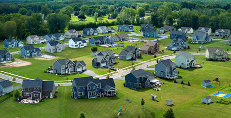 Obraz premium Low-density two story private homes with large lot size and green grassy lawns in summer season. Rural residential suburbs with upscale suburban houses outside of Rochester, New York