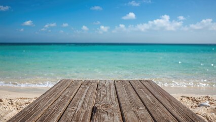 Fototapeta premium Vacant wooden dock facing a sunlit beach and sea