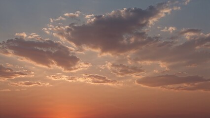 Light clouds moving above a lowering sun