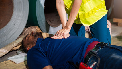 CPR Training, Emergency First Aid in Factory, Safety Worker Helps Injured Man After Workplace Accident