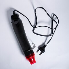 Wired electric heat gun object for diy shrink paper craft isolated on white background from top angle view.