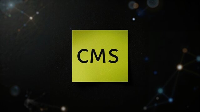 Content Management System acronym CMS written on a sticky note against a dark background