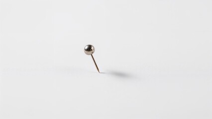 Close-up image of a white note attached by a pin on a neutral background, illustrating business stationery and concepts