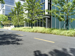enpty asphalt road with modern office building