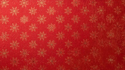 Full frame image of red seasonal wrapping paper with a repeating design of gold snowflakes