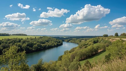 Fototapeta premium Picturesque gorge environment with waterway, verdant grass, and bright summer atmosphere