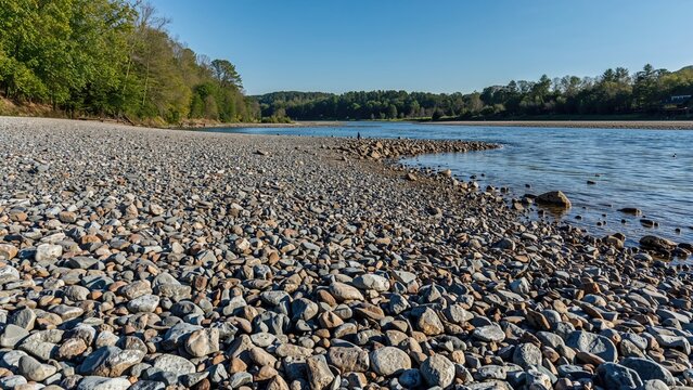 Pebbled river edge showcasing earthy gray and brown colors.